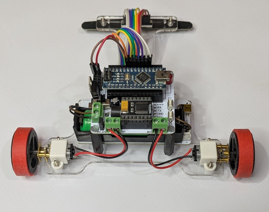 Clear acrylic line-follower robot with Arduino Nano, motor driver, and sensor bar